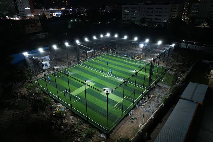 Aerial view of the pitch glowing under floodlights