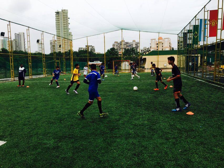 Players mid-match on the floodlit football turf